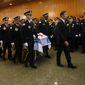 In this file photo, the casket of Chicago police Officer Ella French is brought through the vestibule before the funeral service for French on Thursday, Aug. 19, 2021, at St. Rita of Cascia Shrine Chapel in Chicago.  French was killed and her partner was seriously wounded during an Aug. 7 traffic stop on the city&#39;s South Side. The National Fraternal Order of Police on Jan. 3, 2022, released a report showing 63 officers were gunned down while on the job in 2021, up from 47 in 2020, 50 in 2019 and 53 in 2018.(Antonio Perez/Chicago Tribune via AP, Pool)