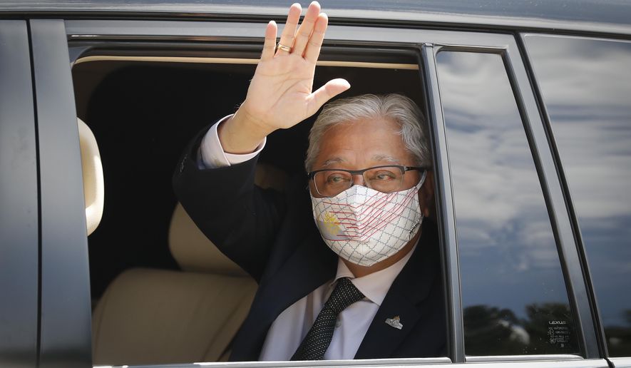 Former Deputy Prime Minister Ismail Sabri Yaakob waves to media as he leave after meeting with the King at national palace in Kuala Lumpur, Malaysia, Thursday, Aug. 19, 2021. Yaakob appeared to have won majority support to be Malaysia&#39;s new leader. His backers have been summoned to the palace Thursday to verify to the king they support him. (AP Photo/FL Wong)