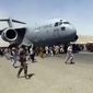 In this Aug. 16, 2021, photo, hundreds of people run alongside a U.S. Air Force C-17 transport plane as it moves down a runway of the international airport, in Kabul, Afghanistan. (Verified UGC via AP) **FILE**