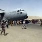 In this Aug. 16, 2021, file photo, hundreds of people run alongside a U.S. Air Force C-17 transport plane as it moves down a runway of the international airport, in Kabul, Afghanistan. (Verified UGC via AP, File)