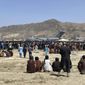 In this Monday, Aug. 16, 2021, file photo hundreds of people gather near a U.S. Air Force C-17 transport plane along the perimeter at the international airport in Kabul, Afghanistan. Hundreds of Western nationals and Afghan workers have been flown to safety since the Taliban reasserted control over the country. Yet still unprotected, and in hiding, are untold numbers of Afghans who tried to build a fledgling democracy. They include Afghans who worked with foreign forces, and who are now stranded and being hunted by the Taliban, along with aid workers. (AP Photo/Shekib Rahmani, File)