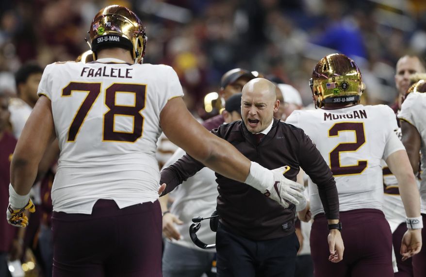 FILE - Minnesota head coach P.J. Fleck greets offensive lineman Daniel Faalele (78) after a play during the Quick Lane Bowl NCAA college football game against Georgia Tech in Detroit, in this Wednesday, Dec. 26, 2018, file photo. This mammoth lineman – he’s 6-foot-9 and 380 pounds – was Minnesota’s starting right tackle in 2018 and 2018. He should step right back into that role this year after sitting out the 2020 season. (AP Photo/Carlos Osorio, File)