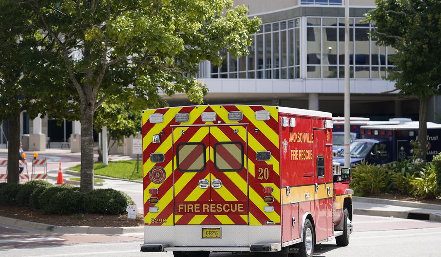 An emergency vehicle arrives at Wolfson Children&#39;s Hospital next to Baptist Heart Hospital Wednesday, Aug. 11, 2021, in Jacksonville, Fla. Duval County, which consists almost entirely of Jacksonville, is one of the hardest-hit areas with COVID infection rates in the top third in the state. (AP Photo/John Raoux)
