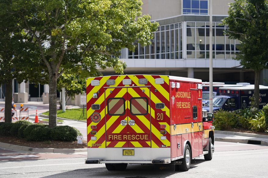 An emergency vehicle arrives at Wolfson Children&#x27;s Hospital next to Baptist Heart Hospital Wednesday, Aug. 11, 2021, in Jacksonville, Fla. Duval County, which consists almost entirely of Jacksonville, is one of the hardest-hit areas with COVID infection rates in the top third in the state. (AP Photo/John Raoux)