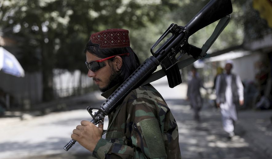 A Taliban fighter stands guard at a checkpoint in the Wazir Akbar Khan neighborhood in the city of Kabul, Afghanistan, Sunday, Aug. 22, 2021. A panicked crush of people trying to enter Kabul&#39;s international airport killed several Afghan civilians in the crowds, the British military said Sunday, showing the danger still posed to those trying to flee the Taliban&#39;s takeover of the country. (AP Photo/Rahmat Gul)