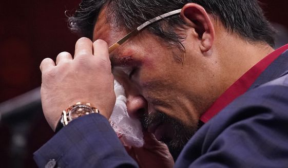 Manny Pacquiao, of the Philippines, wipes his eye at a news conference after his loss to Yordenis Ugas, of Cuba, in a welterweight championship boxing match Saturday, Aug. 21, 2021, in Las Vegas. (AP Photo/John Locher) **FILE**