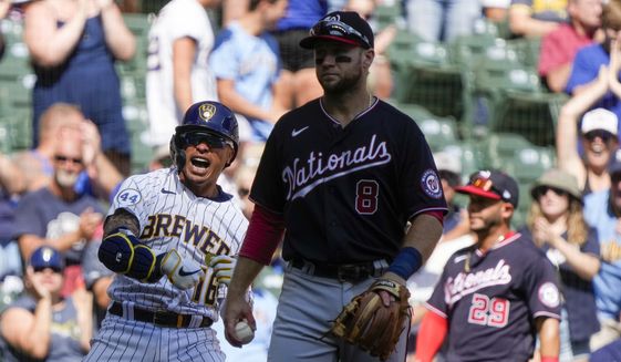 Milwaukee Brewers&#39; Kolten Wong reacts after hitting a two-run scoring triple during the fourth inning of a baseball game against the Washington Nationals Sunday, Aug. 22, 2021, in Milwaukee. (AP Photo/Morry Gash)