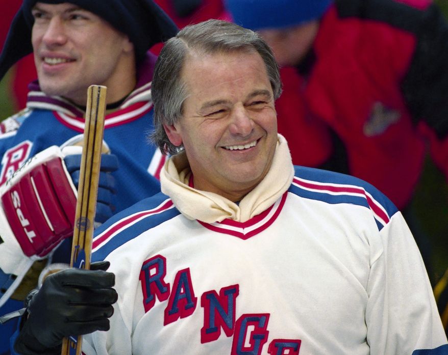 In this Jan. 20, 1994, file photo, former New York Rangers player Rod Gilbert, foreground, and team captain Mark Messier attend a hockey clinic at the skating rink at Rockefeller Center in New York. Gilbert, the Hall of Fame right wing who starred for the Rangers and helped Canada win the 1972 Summit Series, had died. He was 80. Gilbert’s family confirmed the death to Rangers on Sunday, Aug. 22, 2021. (AP Photo/Mark Lennihan, File)