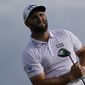 Jon Rahm, of Spain, watches his shot off the 15th tee in the third round at the Northern Trust golf tournament, Saturday, Aug. 21, 2021, at Liberty National Golf Course in Jersey City, N.J. (AP Photo/John Minchillo) **FILE**