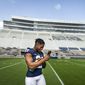 Penn State running back Noah Cain makes a call during photo day for the NCAA college football team Saturday, Aug. 21, 2021, in State College, Pa. (Joe Hermitt/The Patriot-News via AP) **FILE**