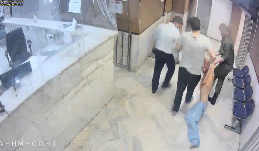 In this undated frame grab taken from video shared with The Associated Press by a self-identified hacker group called &quot;The Justice of Ali,&quot; guards drag an emaciated prisoner, at Evin prison in Tehran, Iran. The alleged hackers said the release of the footage was an effort to show the grim conditions at the prison, known for holding political prisoners and those with ties abroad who are often used as bargaining chips in negotiations with the West. (The Justice of Ali via AP)