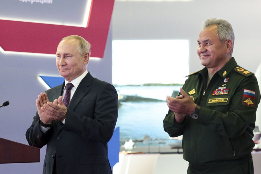 Russian President Vladimir Putin, left, and Russian Defense Minister Sergei Shoigu applaud during the launching of construction of new nuclear submarines and other warships via video conference on the side of the International Military Technical Forum Army-2021 in Alabino, outside Moscow, Russia, Monday, Aug. 23, 2021. Putin has launched the construction of new nuclear submarines and other warships, part of a sweeping military modernization effort amid tensions with the West. He gave orders for two nuclear submarines armed with intercontinental ballistic missiles along with two diesel-powered submarines and two corvettes at shipyards in Severodvinsk, St. Petersburg and Komsomolsk-on-Amur. (Mikhail Klimentyev, Sputnik, Kremlin Pool Photo via AP)