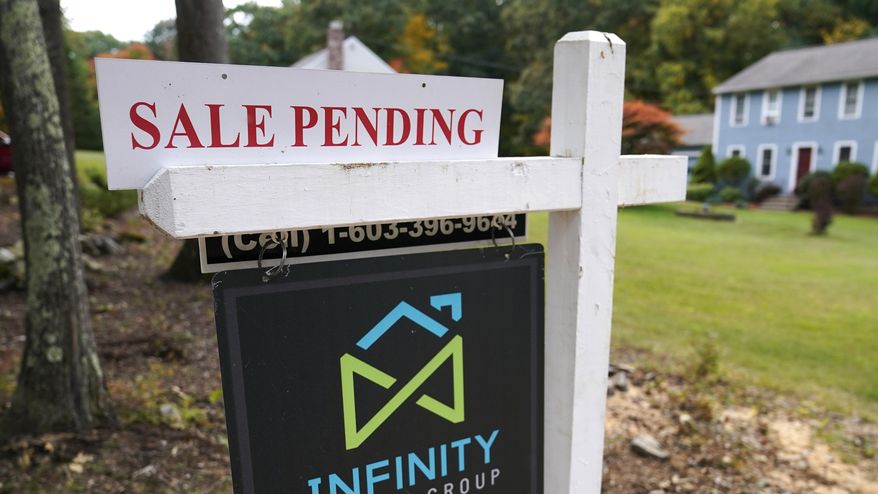 In this Sept. 29, 2020, file photo, a sale pending sign is displayed outside a residential home for sale in East Derry, N.H. Sales of previously occupied U.S. homes rose in July for the second month in a row, though they only increased modestly from a year ago, suggesting the red-hot housing market may be cooling off a little. Existing homes sales rose 2% last month from June to a seasonally-adjusted annual rate of 5.99 million units, the National Association of Realtors said Monday, Aug. 23, 2021. (AP Photo/Charles Krupa, File)