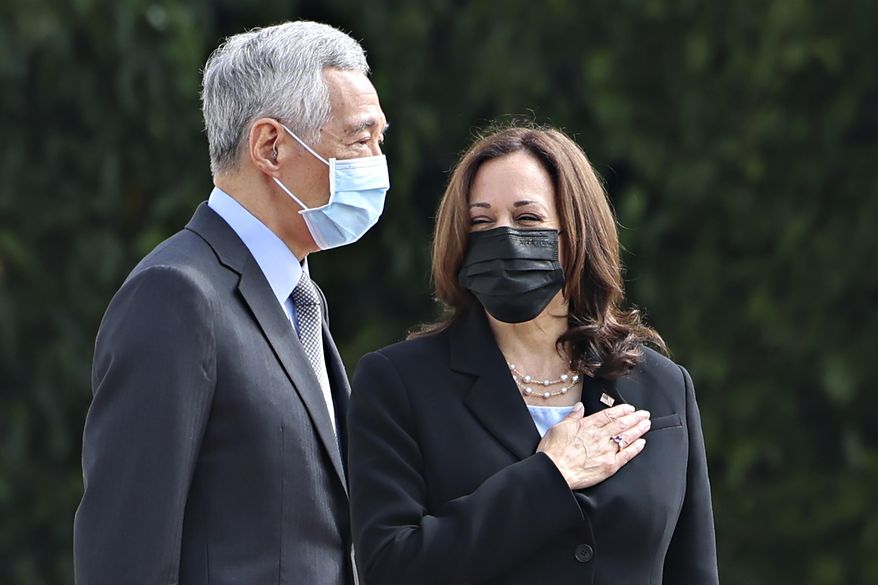 U.S. Vice President Kamala Harris, right, stands next to Singapore&#x27;s Prime Minister Lee Hsien Loong during a welcome ceremony at the Istana in Singapore Monday, Aug. 23, 2021. (Evelyn Hockstein/Pool Photo via AP)