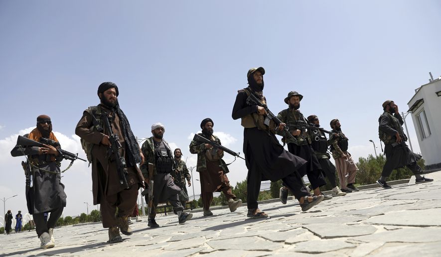 In this Aug. 19, 2021, file photo, Taliban fighters patrol in Kabul, Afghanistan. After the Taliban takeover, employees of the collapsed government, civil society activists and women are among the at-risk Afghans who have gone into hiding or are staying off the streets. (AP Photo/Rahmat Gul, File)