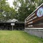 A sign as well as a tank mark the entrance to Fort Pickett Wednesday, Aug. 25, 2021, in Blackstone, Va. (AP Photo/Steve Helber) ** FILE **
