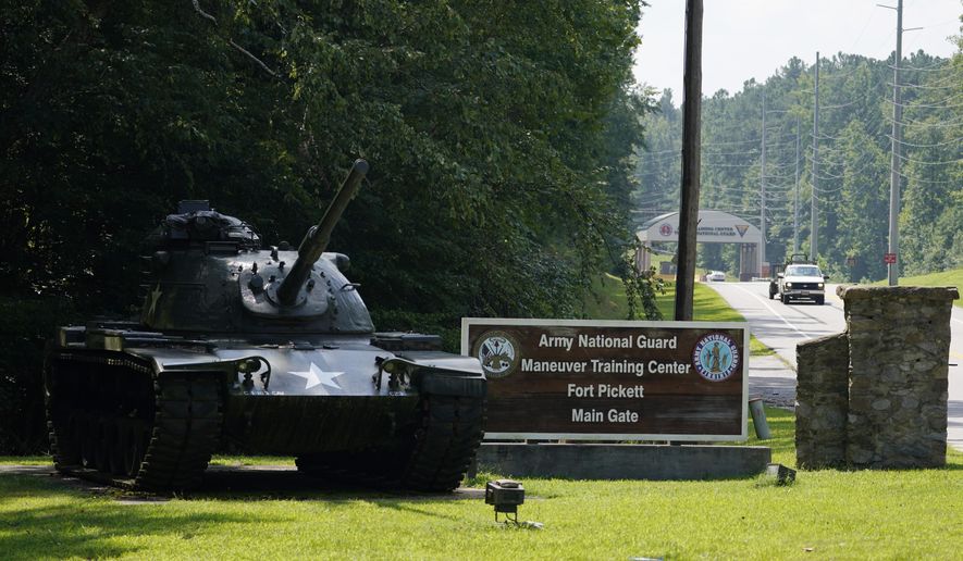 Traffic moves toward a tank and sign at the main entrance to Fort Pickett Wednesday, Aug. 25, 2021, in Blackstone, Va. Afghan refugees who have been prescreened by the U.S. Department of Homeland Security have been taken to Fort Lee as well as Fort Pickett according to Virginia Gov. Ralph Northam. (AP Photo/Steve Helber)
