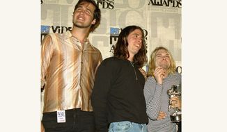 Nirvana band members Krist Novoselic, from left, Dave Grohl and Kurt Cobain pose after receiving the award for best alternative video for &quot;In Bloom&quot; at the 10th annual MTV Video Music Awards on Sept. 2, 1993, in Universal City, Calif. A 30-year-old man who appeared nude at 4 months old in 1991 on the cover of Nirvana&#39;s &quot;Nevermind&quot; album is suing the band and others, alleging the image is child pornography they have profited from. The suit, filed by Spencer Elden on Tuesday, Aug 24, 2021, seeks at least $150,000 from each of more than a dozen defendants, including the Kurt Cobain estate, surviving Nirvana members Novocelic and Grohl and Geffen Records. (AP Photo/Mark J. Terrill, File)