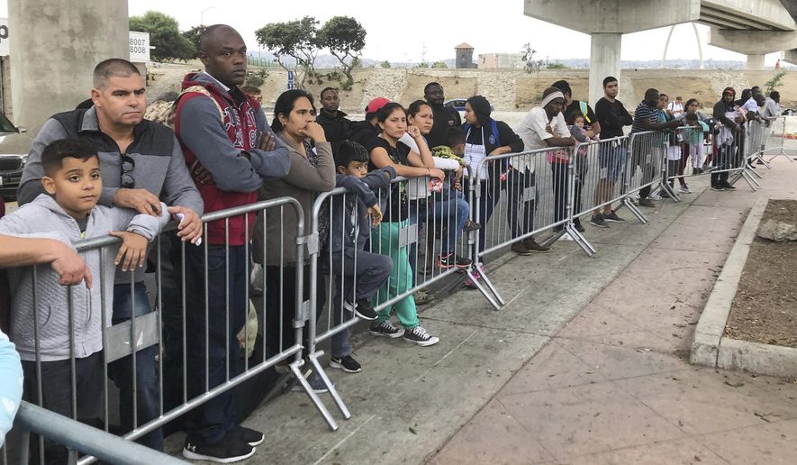 FILE - In this Sept. 26, 2019, file photo asylum seekers in Tijuana, Mexico, listen to names being called from a waiting list to claim asylum at a border crossing in San Diego. The Supreme Court has ordered the reinstatement of the &amp;quot;Remain in Mexico&amp;quot; policy, saying that the Biden administration likely violated federal law by trying to end the Trump-era program that forces people to wait in Mexico while seeking asylum in the U.S. The decision immediately raised questions about what comes next for the future of the policy, also known as the Migrant Protection Protocols. (AP Photo/Elliot Spagat, File)