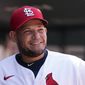 St. Louis Cardinals catcher Yadier Molina smiles in the dugout during the ninth inning of a baseball game against the Detroit Tigers Wednesday, Aug. 25, 2021, in St. Louis. (AP Photo/Jeff Roberson)