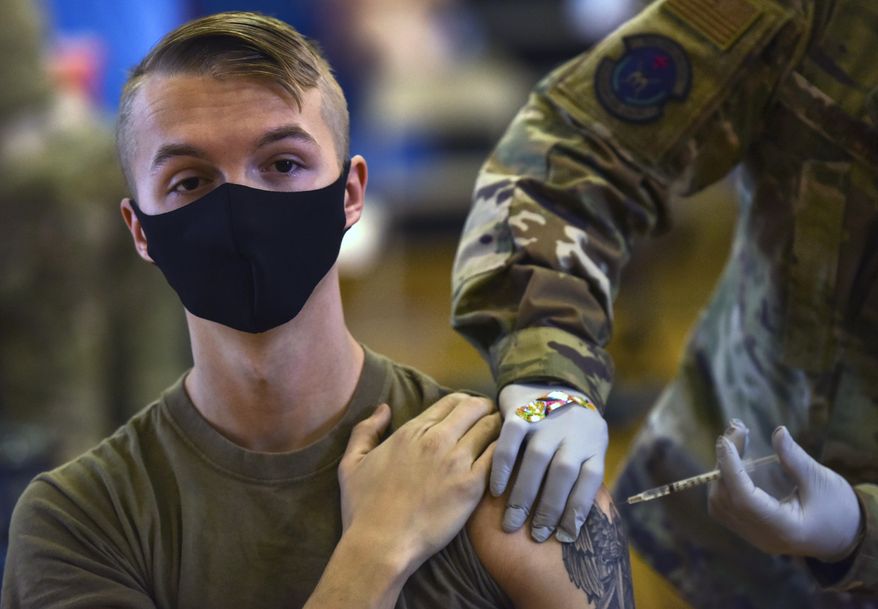 In this file photo, Hickam 15th Medical Group hosts the first COVID-19 mass vaccination on Joint Base Pearl Harbor-Hickam. As of Dec. 1, 2021, while nearly 10,000 U.S. military personnel have applied for religious waivers to avoid the COVID-19 vaccine, so far not a single one has been approved, according to publicly available Pentagon data. (U.S. Air Force Tech. Sgt. Anthony Nelson Jr./Department of Defense via AP) **FILE**