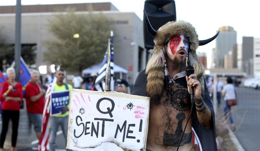 In this Nov. 5, 2020, photo, Jacob Anthony Chansley, who also goes by the name Jake Angeli, a QAnon believer, speaks to a crowd of President Donald Trump supporters outside of the Maricopa County Recorder&#x27;s Office where votes in the general election are being counted, in Phoenix. (AP Photo/Dario Lopez-Mills) **FILE**