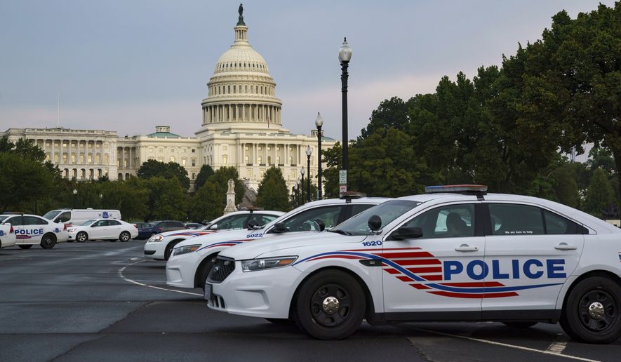 Washington Metropolitan Police vehicles hold on the perimeter of the Capitol in Washington, Thursday evening, Aug. 26, 2021. (AP Photo/J. Scott Applewhite) ** FILE **