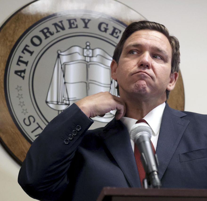 Florida Governor Ron DeSantis listens to a question during a press conference with Florida Attorney General Ashley Moody in Orlando, Fla., Thursday, Aug. 26, 2021, announcing that the state&#39;s Department of Children and Families (DCF) and the Florida Office of Attorney General have recovered $5 million from the Florida Coalition Against Domestic Violence. (Joe Burbank/Orlando Sentinel via AP)