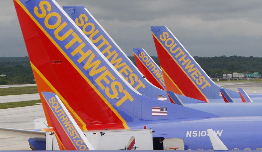 In this May 16, 2008 file photo, Southwest Airlines jets are seen parked at their gates at Baltimore Washington International Airport in Baltimore, Md. Southwest Airlines will reduce flights for the rest of the year as it tries to restore an operation that stumbled over the summer and now faces lower demand because of the rise in coronavirus cases. Southwest said Thursday, AUg. 26, 2021 it will cut its September schedule by 27 flights a day, or less than 1%, and chop 162 flights a day, or 4.5% of the schedule, from early October through Nov. 5. (AP Photo/Charles Dharapak, file)