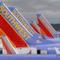 In this May 16, 2008 file photo, Southwest Airlines jets are seen parked at their gates at Baltimore Washington International Airport in Baltimore, Md. Southwest Airlines will reduce flights for the rest of the year as it tries to restore an operation that stumbled over the summer and now faces lower demand because of the rise in coronavirus cases. Southwest said Thursday, AUg. 26, 2021 it will cut its September schedule by 27 flights a day, or less than 1%, and chop 162 flights a day, or 4.5% of the schedule, from early October through Nov. 5. (AP Photo/Charles Dharapak, file)