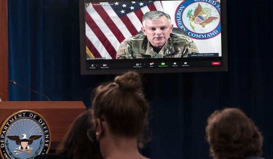 Air Force Gen. Glen VanHerck, Commander, U.S. Northern Command and North American Aerospace Defense Command in Colorado Springs, Colo., appears on a screen as he speaks about the situation in Afghanistan and evacuation of Afghans, during a virtual briefing moderated by Pentagon spokesman John Kirby, not pictured, at the Pentagon in Washington, Friday, Aug. 27, 2021. (AP Photo/Manuel Balce Ceneta)