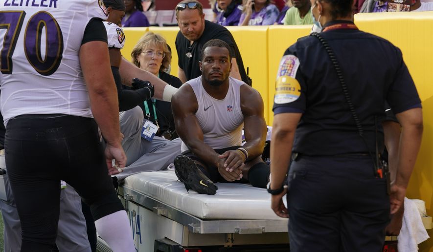 Baltimore Ravens running back J.K. Dobbins (27) is taken off the field after suffering an injury in the first half of a preseason NFL football game against the Washington Football Team, Saturday, Aug. 28, 2021, in Landover, Md. (AP Photo/Carolyn Kaster)