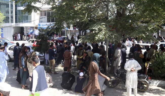 Afghans wait for hours to try to withdraw money, in front of Kabul Bank, in Kabul, Afghanistan, Saturday, Aug. 28, 2021. (AP Photo/Khwaja Tawfiq Sediqi)
