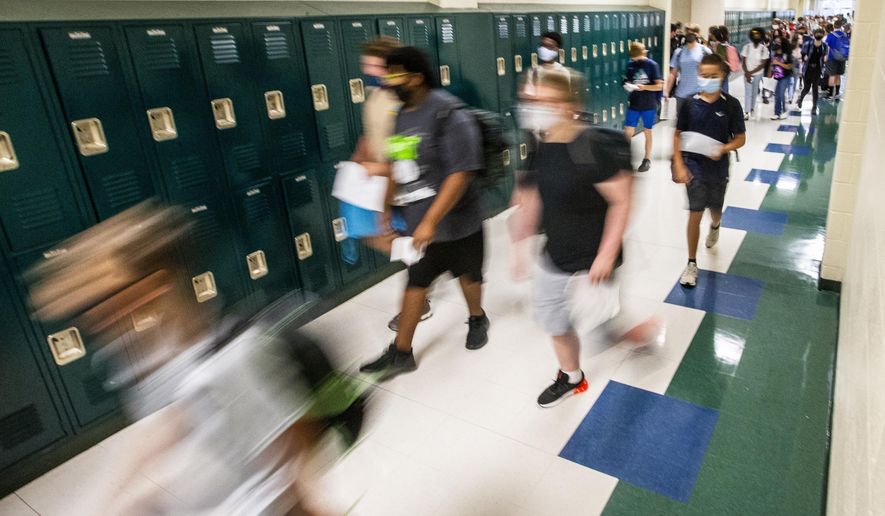 Students walk to their first class on the first day of school at Kernodle Middle School in Greensboro, N.C., on Monday, Aug. 23, 2021.  The federal government has provided $190 billion in pandemic aid to schools since March 2020. This is more than quadruple what the U.S. Education Department spends on K-12 schools in a typical year.  (Woody Marshall/News &amp;amp; Record via AP)