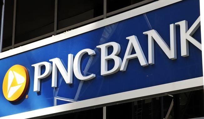 This is the sign on a PNC Bank branch in downtown Pittsburgh, Sunday, May 31, 2020. PNC Bank is the latest large U.S. financial services company to increase wages in a bid to keep and attract employees. It is raising its minimum wage to $18 an hour while also giving higher-paid workers a bump in pay. The bank said Monday, Aug. 30, 2021, that the wage increase will apply to both PNC employees as well as those working for BBVA USA, which PNC acquired last year. (AP Photo/Gene J. Puskar) ** FILE **