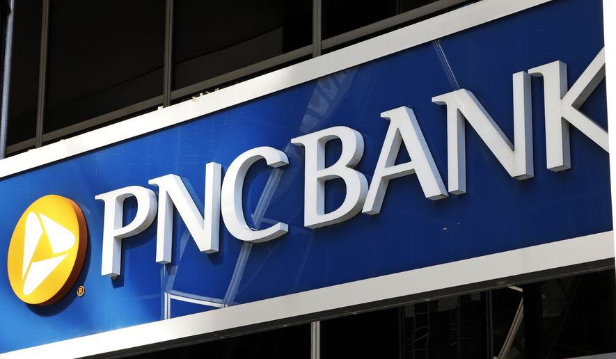 This is the sign on a PNC Bank branch in downtown Pittsburgh, Sunday, May 31, 2020. PNC Bank is the latest large U.S. financial services company to increase wages in a bid to keep and attract employees. It is raising its minimum wage to $18 an hour while also giving higher-paid workers a bump in pay. The bank said Monday, Aug. 30, 2021, that the wage increase will apply to both PNC employees as well as those working for BBVA USA, which PNC acquired last year. (AP Photo/Gene J. Puskar) ** FILE **