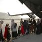 Afghans prepare to to be evacuated aboard a Qatari transport plane, at Hamid Karzai International Airport in Kabul, Afghanistan, August, 18, 2021. Qatar played an out-sized role in U.S. efforts to evacuate tens of thousands of people from Afghanistan. Now the tiny Gulf Arab state is being asked to help shape what is next for Afghanistan because of its ties with both Washington and the Taliban insurgents now in charge in Kabul. (Qatar Government Communications Office via AP)