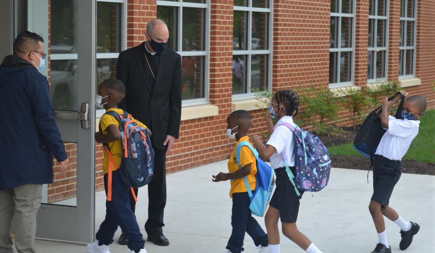 Youngsters enter the first new Catholic school built in Baltimore in roughly 60 years with a mix of enthusiasm and first-day-back jitters, Monday Aug. 30, 2021. The new 65,000 square foot school near downtown Baltimore is an anomaly in the national education landscape where the pandemic has shuttered many parish schools. It&#39;s named after Mother Mary Lange, who started a Catholic school for Black children in 1828 _ the first U.S. Catholic school for African-American youth. (AP Photo/David McFadden)