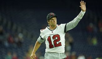 Tampa Bay Buccaneers quarterback Tom Brady (12) waves toward the fans as he leaves the field after an NFL preseason football game against the Houston Texans, Saturday, Aug. 28, 2021, in Houston. (AP Photo/Matt Patterson)