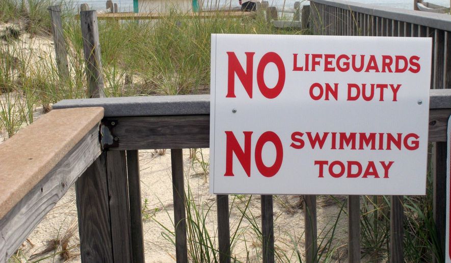 A sign advises beachgoers in Berkeley Township, N.J., that no lifeguards are on duty on Tuesday Aug. 31, 2021, the day after 19-year-old lifeguard Keith Pinto was killed by a bolt of lightning that stuck the beach where he was working. (AP Photo/Wayne Parry) **FILE**