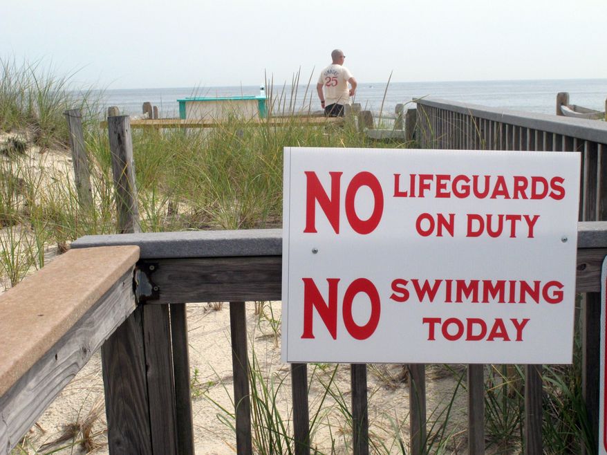 A sign advises beachgoers in Berkeley Township, N.J., that no lifeguards are on duty on Tuesday Aug. 31, 2021, the day after 19-year-old lifeguard Keith Pinto was killed by a bolt of lightning that stuck the beach where he was working. (AP Photo/Wayne Parry) **FILE**