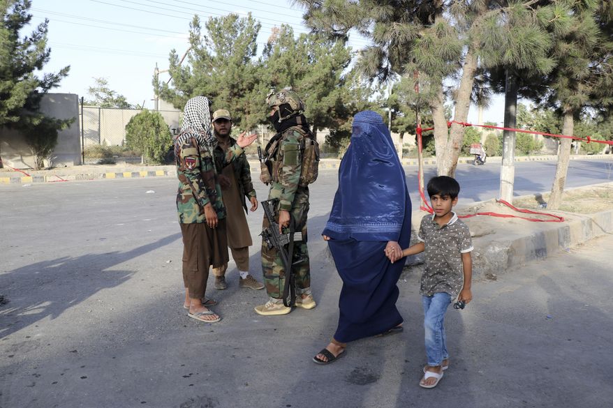 Taliban fighters stand guard at a checkpoint near the gate of Hamid Karzai international Airport in Kabul, Afghanistan, Saturday, Aug. 28, 2021. The Taliban have sealed off Kabul’s airport to most would-be evacuees to prevent large crowds from gathering after this week's deadly suicide attack. The massive U.S.-led airlift was winding down Saturday ahead of a U.S. deadline to withdraw from Afghanistan by Tuesday. (AP Photo/Wali Sabawoon)