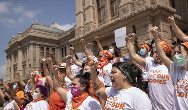 In this Sept. 1, 2021 file photo, women protest against the six-week abortion ban at the Capitol in Austin, Texas. Even before a strict abortion ban took effect in Texas this week, clinics in neighboring states were fielding more and more calls from women desperate for options. The Texas law, allowed to stand in a decision Thursday, Sept. 2, 2021 by the U.S. Supreme Court, bans abortions after a fetal heartbeat can be detected, typically around six weeks. (Jay Janner/Austin American-Statesman via AP File) **FILE**