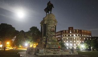 The moon illuminates the statue of Confederate General Robert E. Lee on Monument Avenue Friday June 5, 2020, in Richmond, Va. The Supreme Court of Virginia ruled Thursday, Sept 2, 2021, that the state can take down an enormous statue that has towered over Monument Avenue in the state&#39;s capital for more than a century and has become a symbol of racial injustice. (AP Photo/Steve Helber) **FILE**