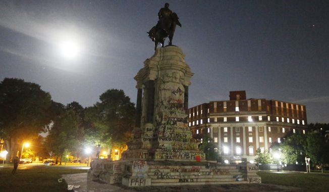 The moon illuminates the statue of Confederate General Robert E. Lee on Monument Avenue Friday June 5, 2020, in Richmond, Va. The Supreme Court of Virginia ruled Thursday, Sept 2, 2021, that the state can take down an enormous statue that has towered over Monument Avenue in the state&#x27;s capital for more than a century and has become a symbol of racial injustice. (AP Photo/Steve Helber) **FILE**
