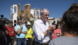 Gov. Phil Murphy speaks with Ashley and Troy Thomas on Thursday, Sept. 2, 2021, after their home was severely damaged by a tornado in Mullica Hill, N.J. A stunned U.S. East Coast woke up Thursday to a rising death toll, surging rivers and destruction after the remnants of Hurricane Ida walloped the region with record-breaking rain, filling low-lying apartments with water and turning roads into car-swallowing canals. (Joe Lamberti /Camden Courier-Post via AP)