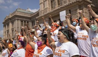In this Sept. 1, 2021 file photo, women protest against the six-week abortion ban at the Capitol in Austin, Texas. Even before a strict abortion ban took effect in Texas this week, clinics in neighboring states were fielding more and more calls from women desperate for options. The Texas law, allowed to stand in a decision Thursday, Sept. 2, 2021 by the U.S. Supreme Court, bans abortions after a fetal heartbeat can be detected, typically around six weeks. (Jay Janner/Austin American-Statesman via AP) **FILE**