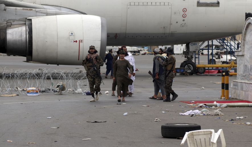 Taliban special forces fighters gather inside the Hamid Karzai International Airport after the U.S. military's withdrawal, in Kabul, Afghanistan, Tuesday, Aug. 31, 2021. The Taliban were in full control of Kabul's airport on Tuesday, after the last U.S. plane left its runway, marking the end of America's longest war. (AP Photo/Khwaja Tawfiq Sediqi) ** FILE **