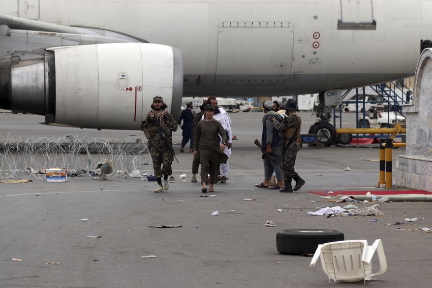 Taliban special forces fighters gather inside the Hamid Karzai International Airport after the U.S. military's withdrawal, in Kabul, Afghanistan, Tuesday, Aug. 31, 2021. The Taliban were in full control of Kabul's airport on Tuesday, after the last U.S. plane left its runway, marking the end of America's longest war. (AP Photo/Khwaja Tawfiq Sediqi) ** FILE **