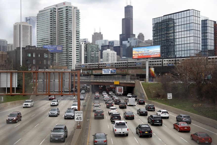 FILE - In this March 31, 2021 file photo, traffic flows along Interstate 90 highway as a Metra suburban commuter train moves along an elevated track in Chicago.   The government’s road safety agency reported Thursday, Sept. 2,  that U.S. traffic deaths in the first quarter of 2021 rose by 10.5% over last year, even as driving has declined.   (AP Photo/Shafkat Anowar, File)
